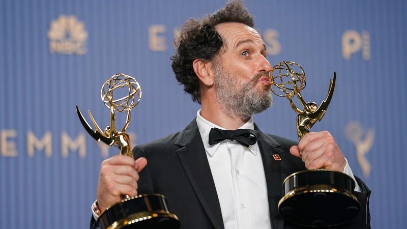 Matthew Rhys holding two Emmy Awards at the 2026 ceremony.