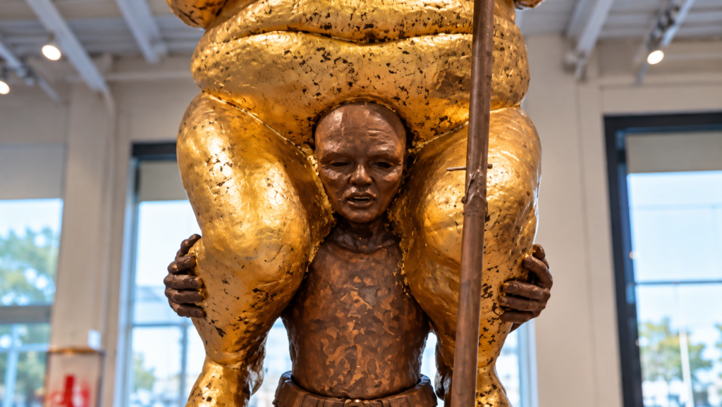 orange plague trump statue